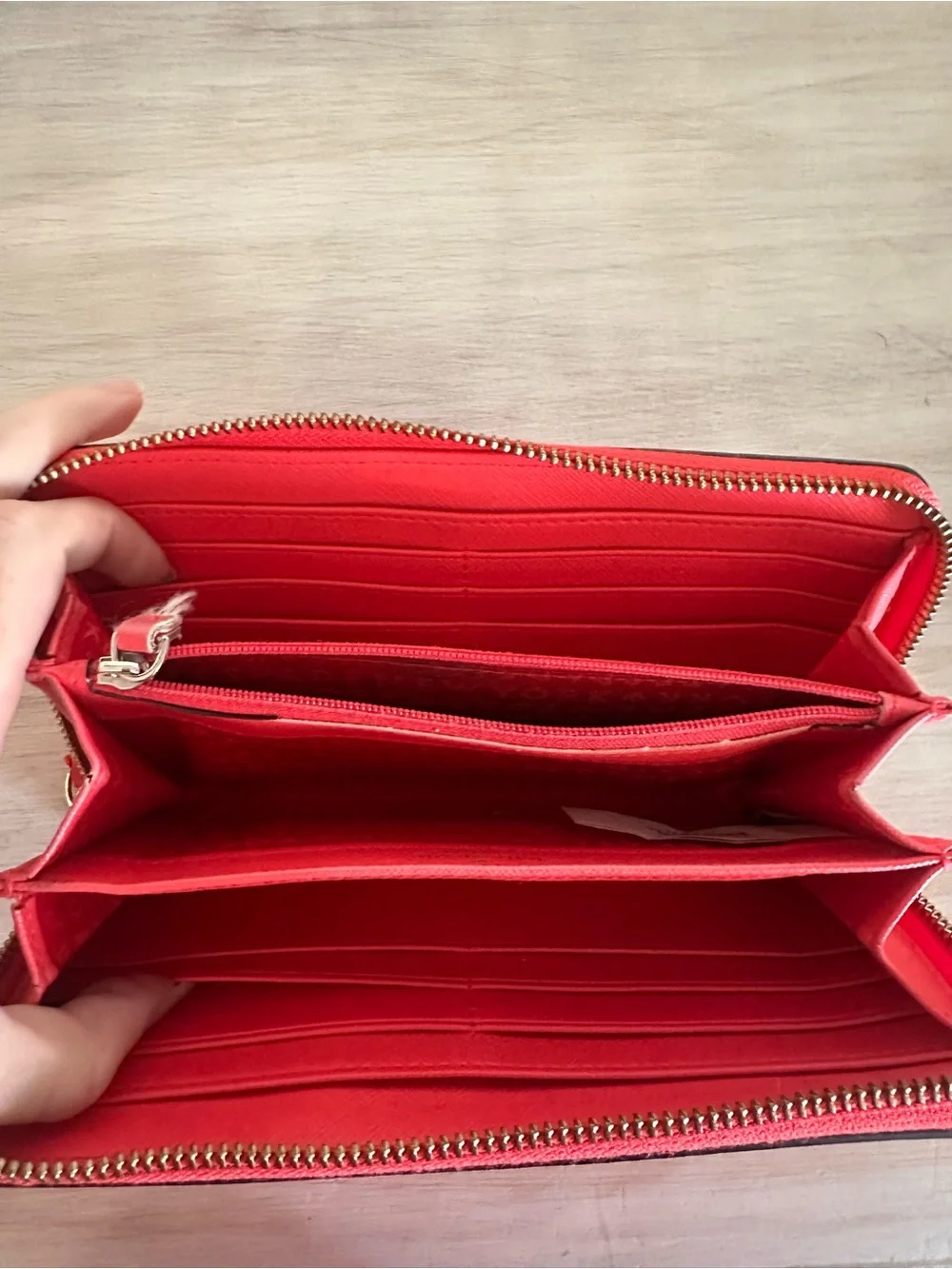 kate spade saffiano zip-around wallet in vibrant red with gold plaque